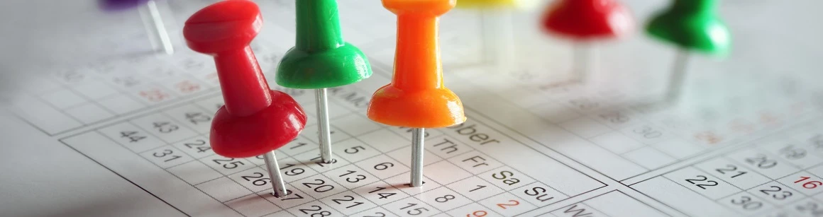Thumbtack in calendar concept for busy, appointment and meeting reminder